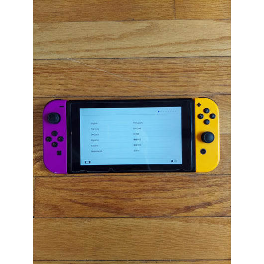 Nintendo Switch console with accessories on a wooden surface