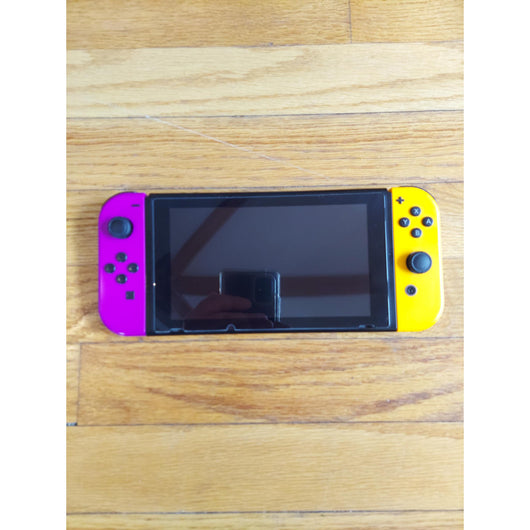 Nintendo Switch console with accessories on a wooden surface