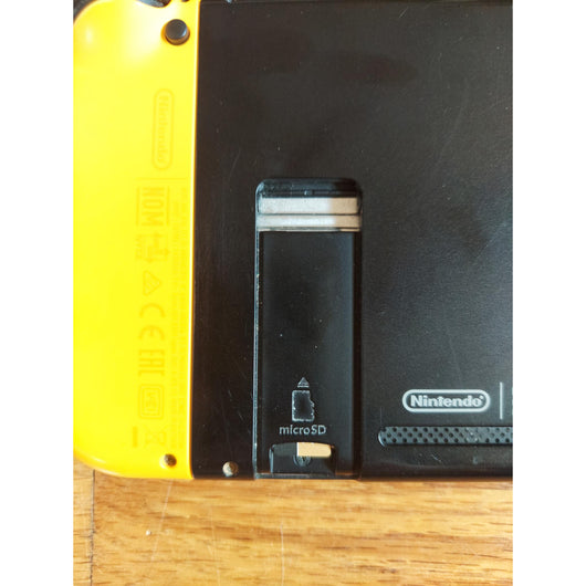 Nintendo Switch console with accessories on a wooden surface