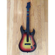 Gaming guitar with colorful buttons on a wooden floor