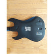 Black electric guitar body with 'Gibson' logo on a wooden surface