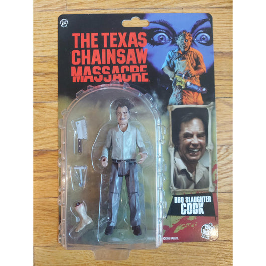 Action figure in packaging with 'The Texas Chainsaw Massacre' BBQ Slaughter Cook
